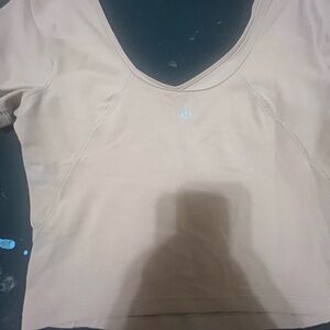 selling because I never wear them.Lululemon top tan color. Size L very stretchy.